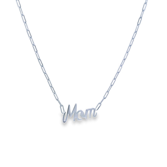 A delicate silver paperclip chain necklace displays a polished cursive "Mom" pendant.