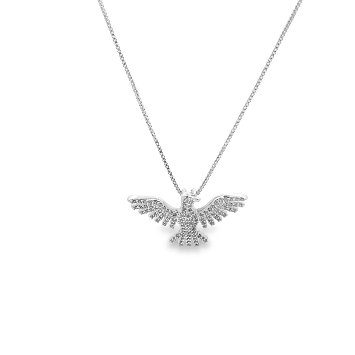 A delicate silver chain necklace features a pavé-set diamond eagle pendant with outstretched wings.
