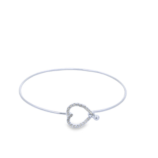 A delicate silver bangle features a sparkling pavé diamond heart clasp centered against a plain white background.