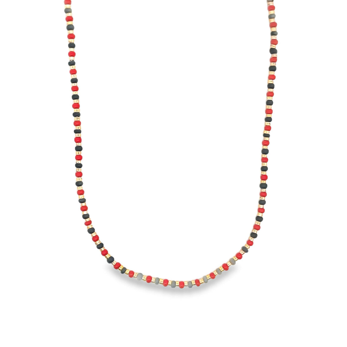 A colorful beaded necklace features alternating red, black, and grey seed beads separated by small gold spacers.