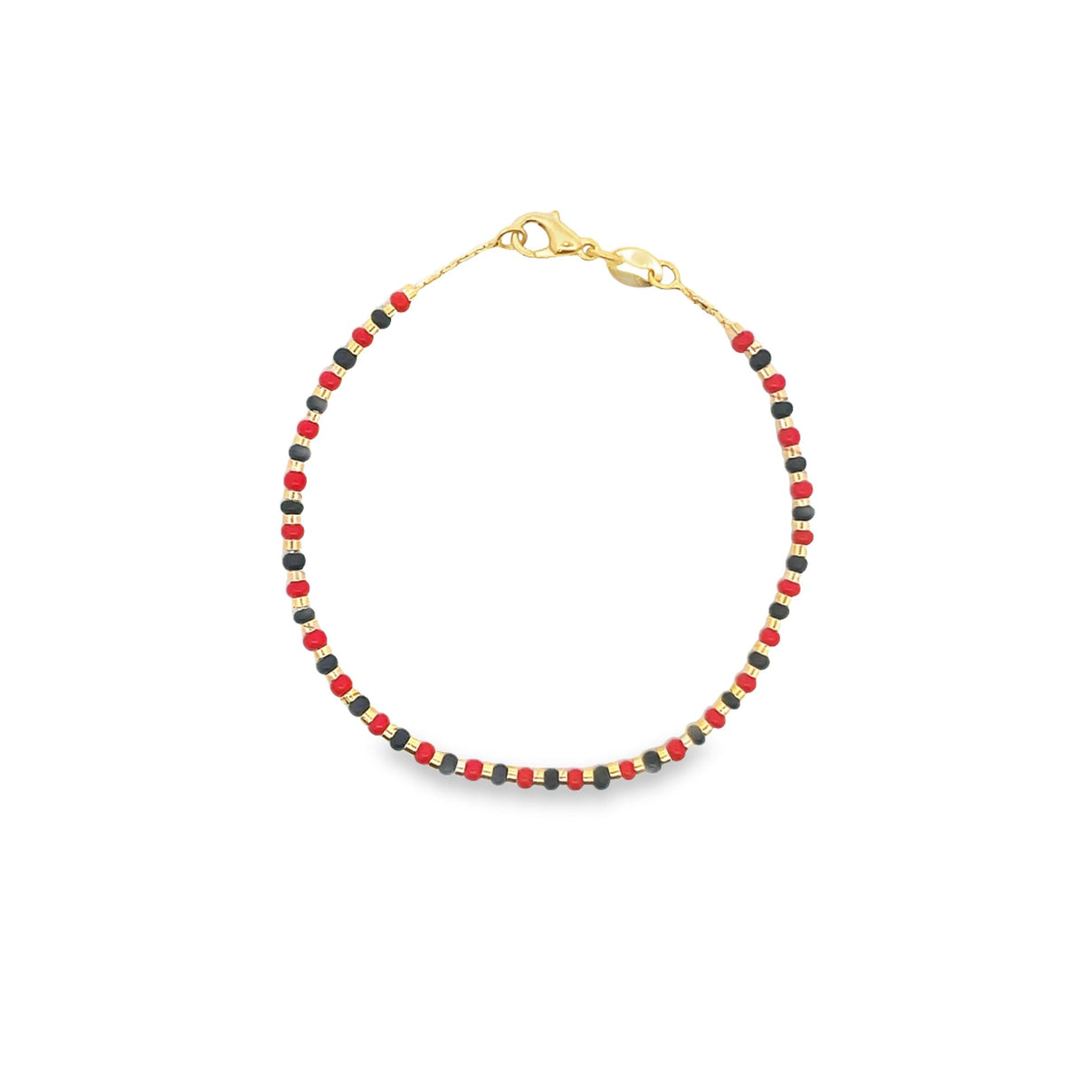 A delicate gold beaded bracelet features alternating red and black seed beads arranged in a vibrant pattern against a white background.