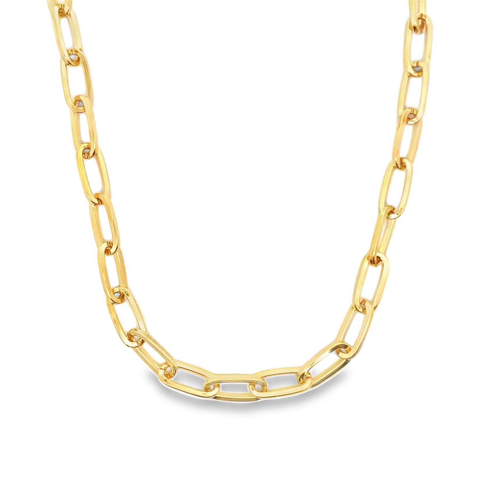 A thick gold paperclip chain necklace rests against a clean white background.