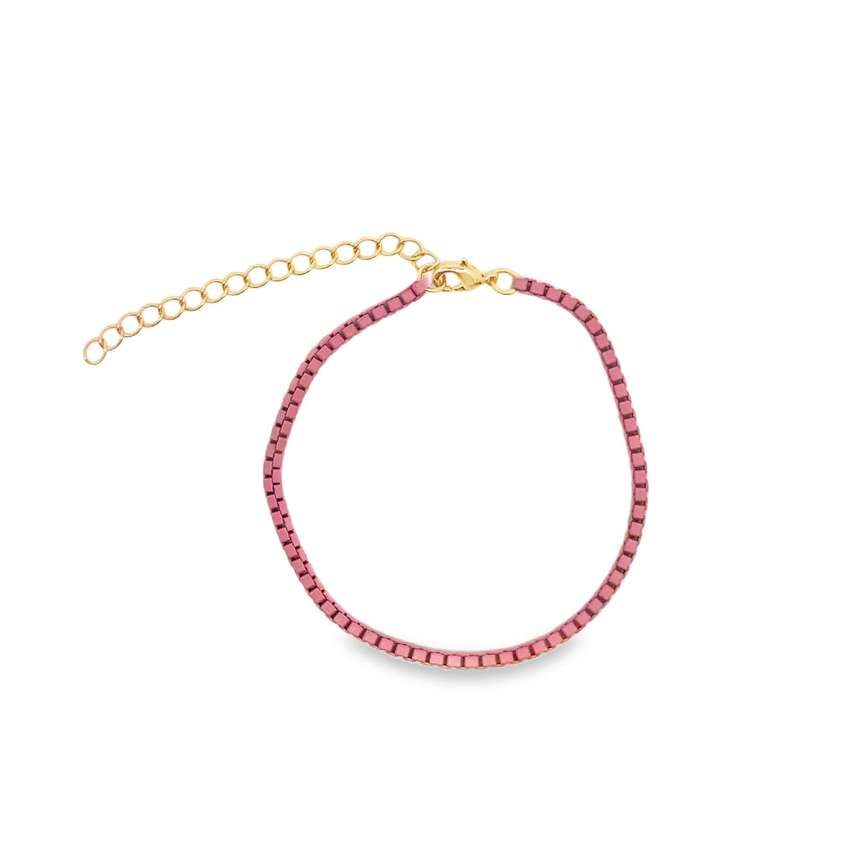 A pink velvet bracelet with an adjustable gold chain sits against a white background.