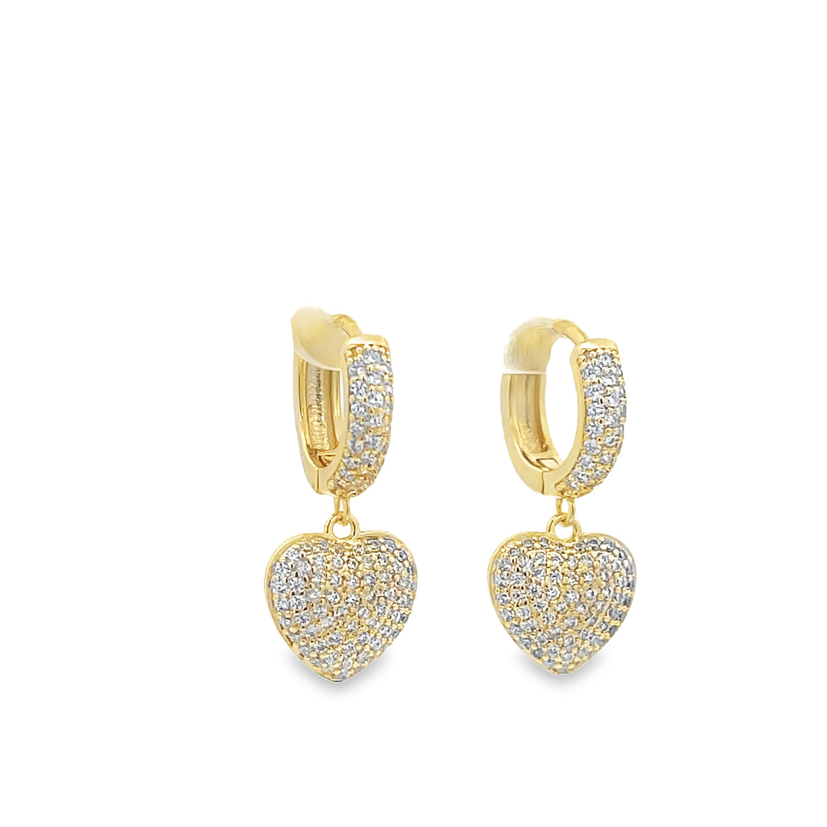 A pair of gold huggie hoop earrings features sparkling pavé-set diamond heart charms hanging against a clean white background.