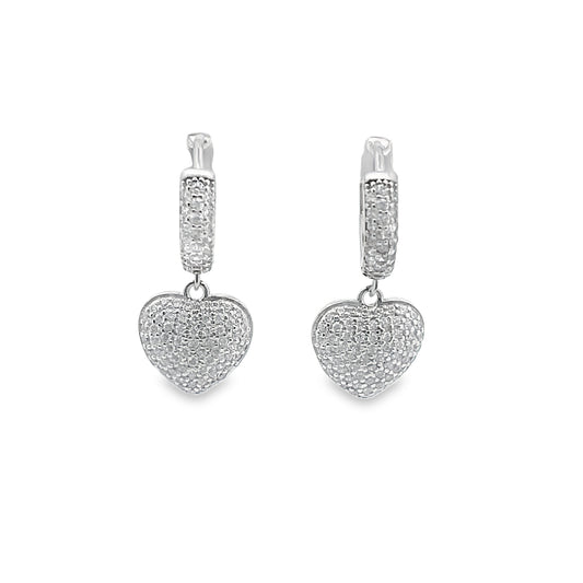 A pair of sparkling silver heart-shaped hoop earrings pave-set with cubic zirconia crystals glistens against a plain white background.