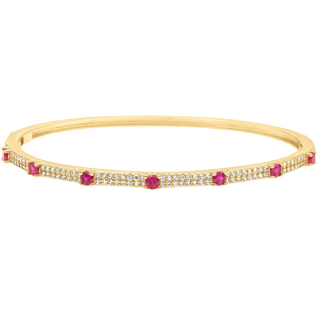 A yellow gold bangle bracelet sparkles with embedded diamonds and evenly spaced round rubies.
