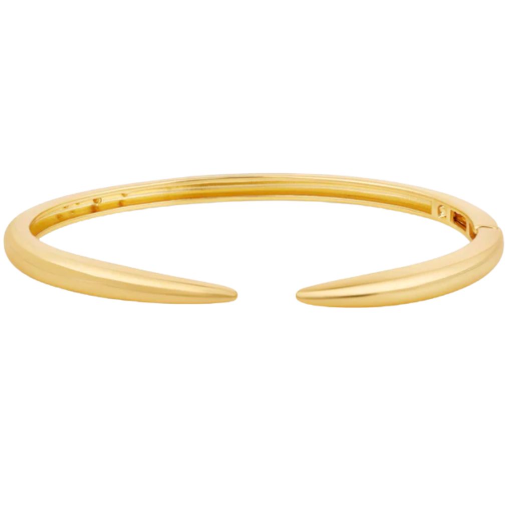 A minimalist gold cuff bracelet features tapered ends against a plain white background.