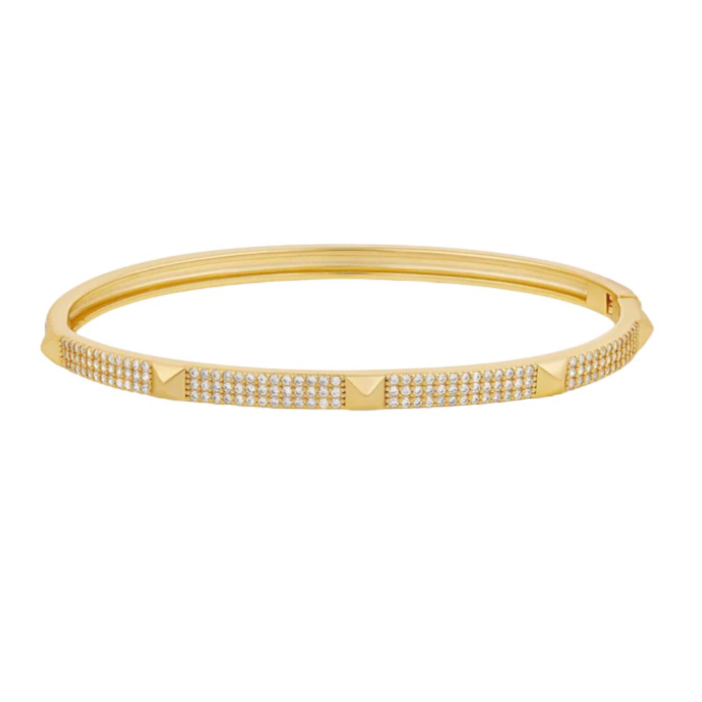 A gold hinged bangle bracelet features three rows of sparkling pavé diamonds and smooth pyramid studs.