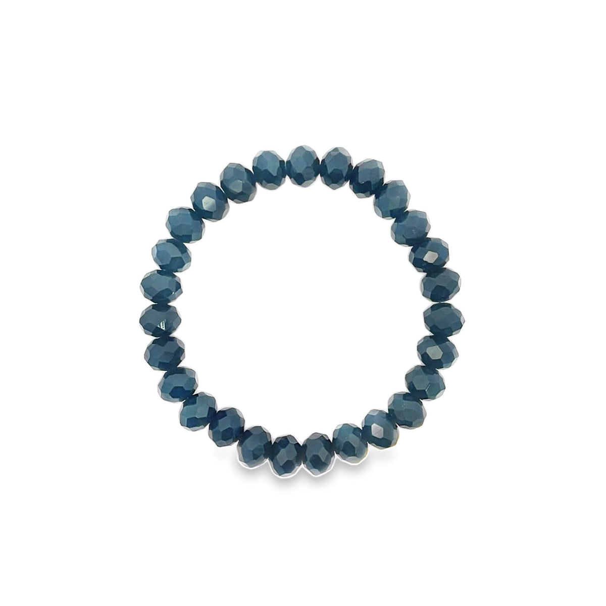 A stretch bracelet made of sparkling dark blue faceted crystal beads rests in a circle on a white background.