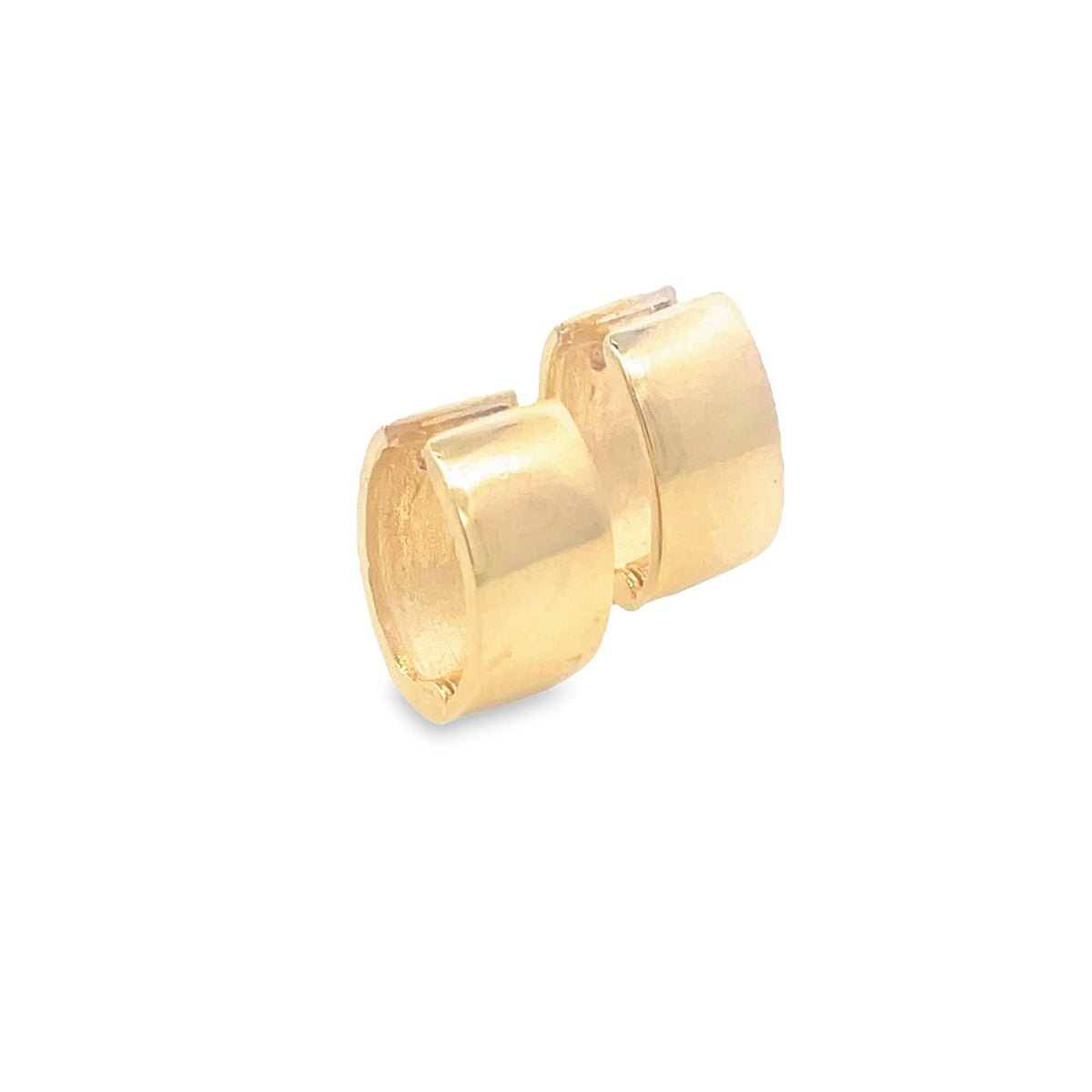 A pair of small gold huggie hoop earrings gleams against a white background.
