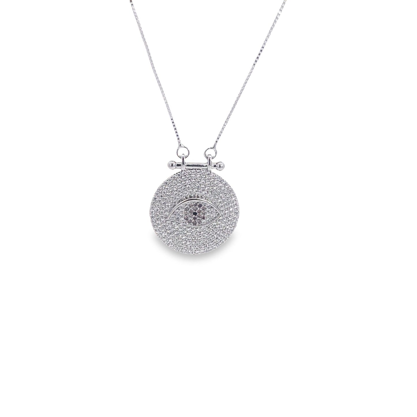 A sparkling silver pendant necklace features a round medallion encrusted with cubic zirconia stones forming an intricate evil eye design.