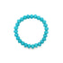 A turquoise beaded stretch bracelet rests against a plain white background.