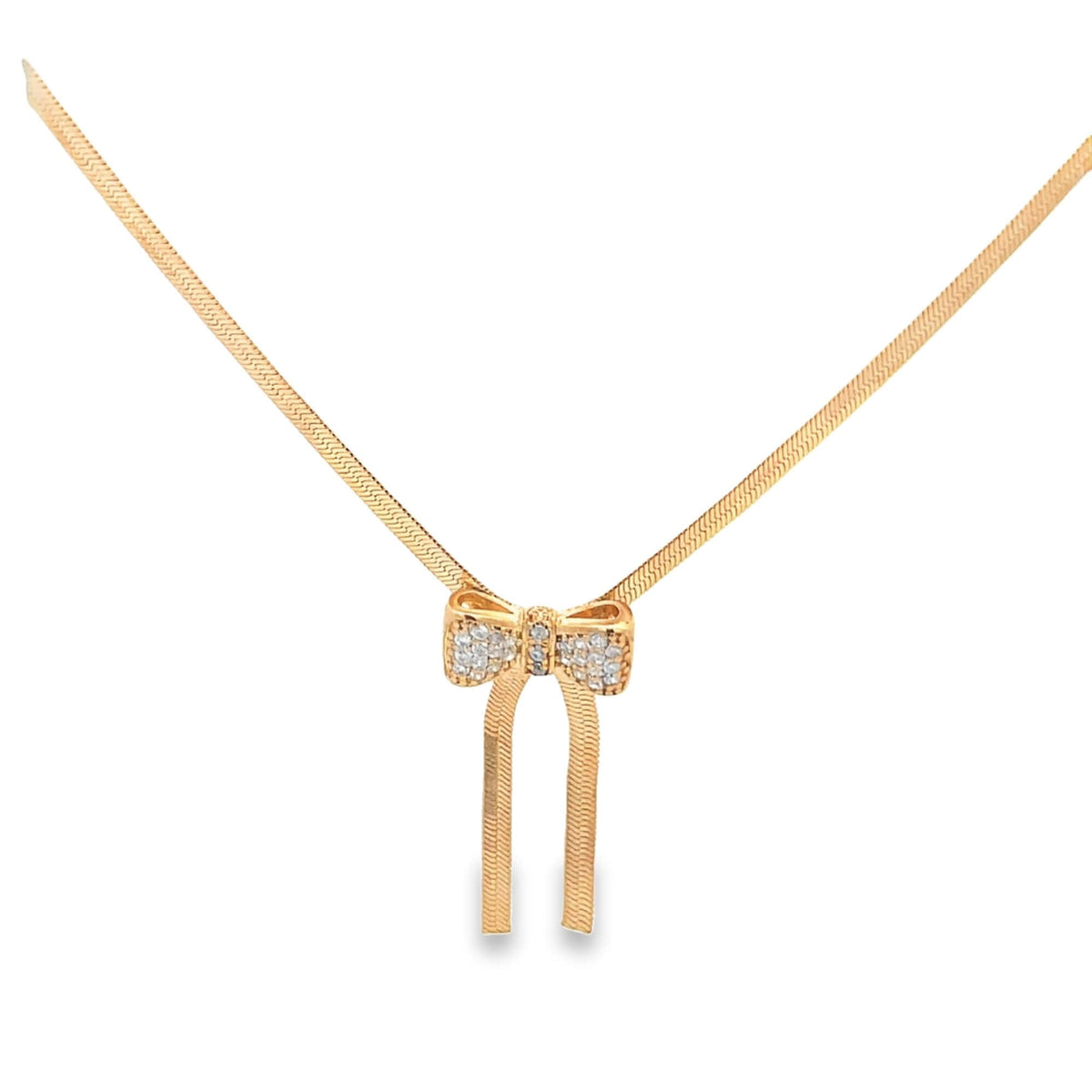A delicate gold herringbone chain necklace features a sparkling diamond-encrusted bow pendant with dangling ribbons.