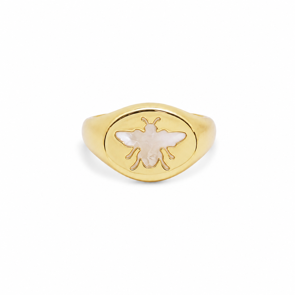 A gold signet ring features an engraved mother-of-pearl bee motif centered on its oval face.
