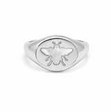 Elegant bee signet ring featuring a genuine Mother of Pearl inlay. Available in Gold Filled and Rhodium finishes with a timeless oval design perfect for everyday wear.