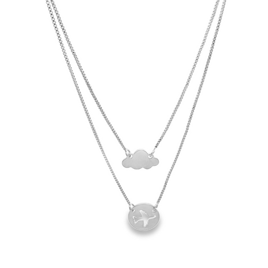 A layered silver box chain necklace features a cloud pendant on the upper tier and a circular pendant with a cut-out airplane on the lower tier.