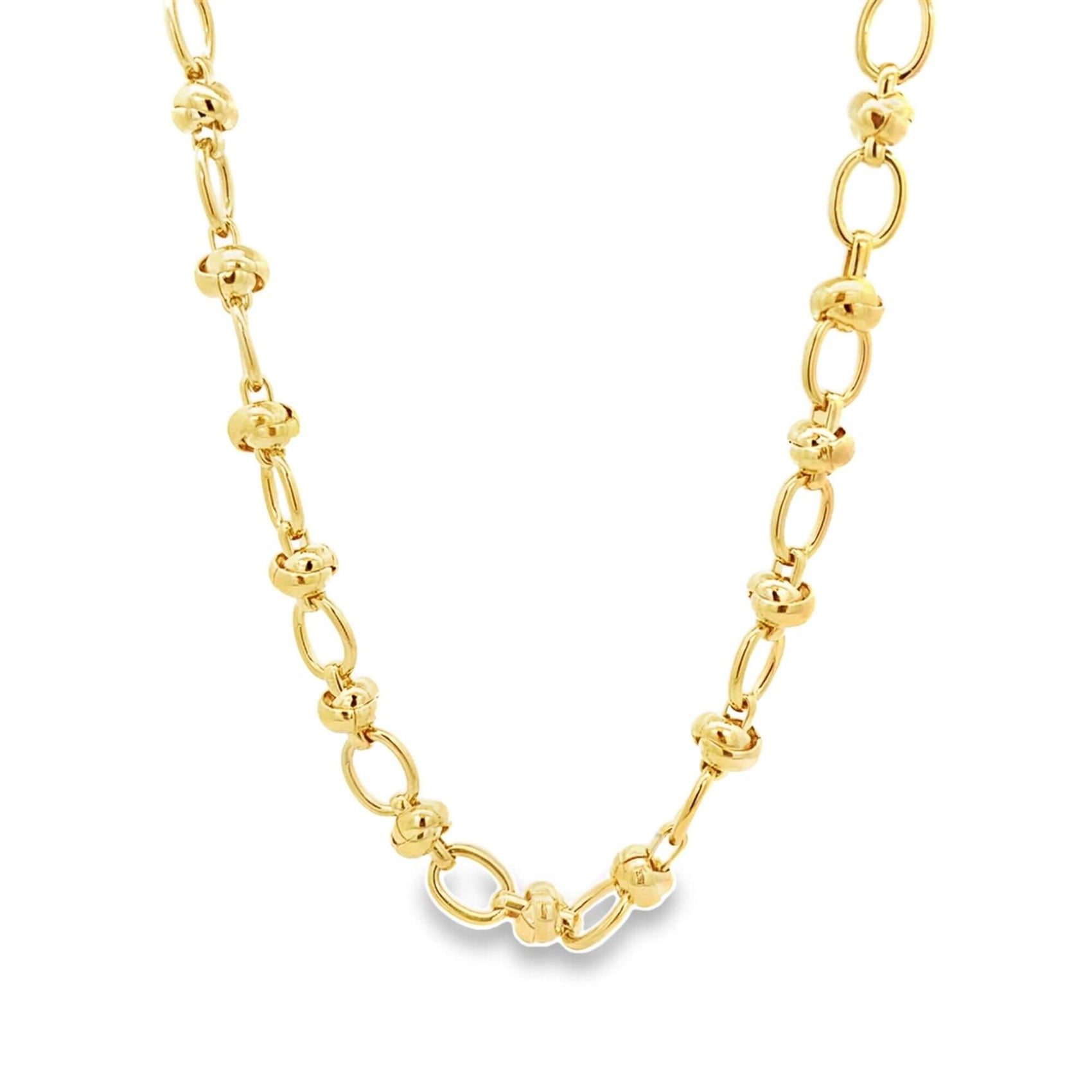 A polished gold station necklace features alternating round beads and oval links against a clean white background.