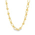 A polished gold station necklace features alternating round beads and oval links against a clean white background.