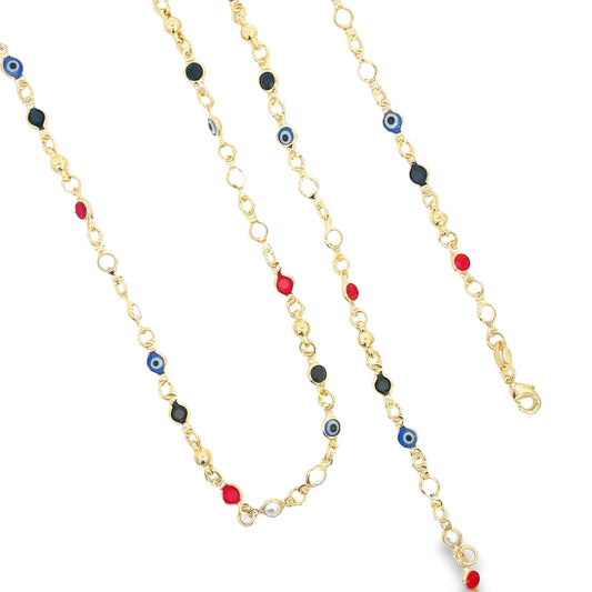 Three delicate gold link chains feature colorful enamel evil eye charms, red stone accents, and black beads arranged vertically against a white background.