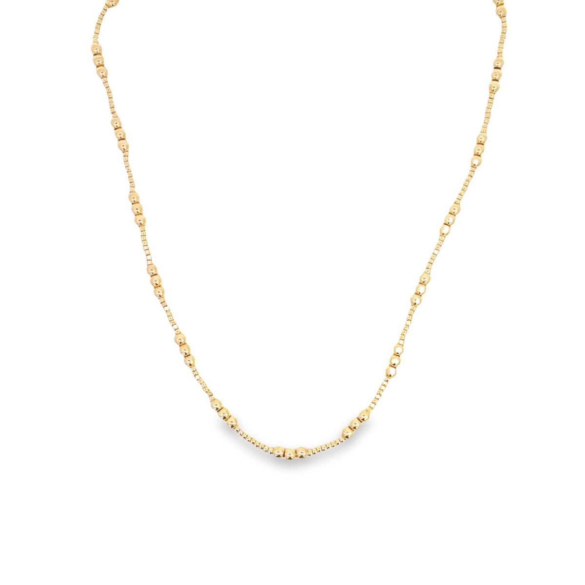 A delicate gold beaded necklace drapes against a clean white background.