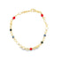A gold link bracelet features colorful enamel evil eye charms and vibrant red beads against a white background.