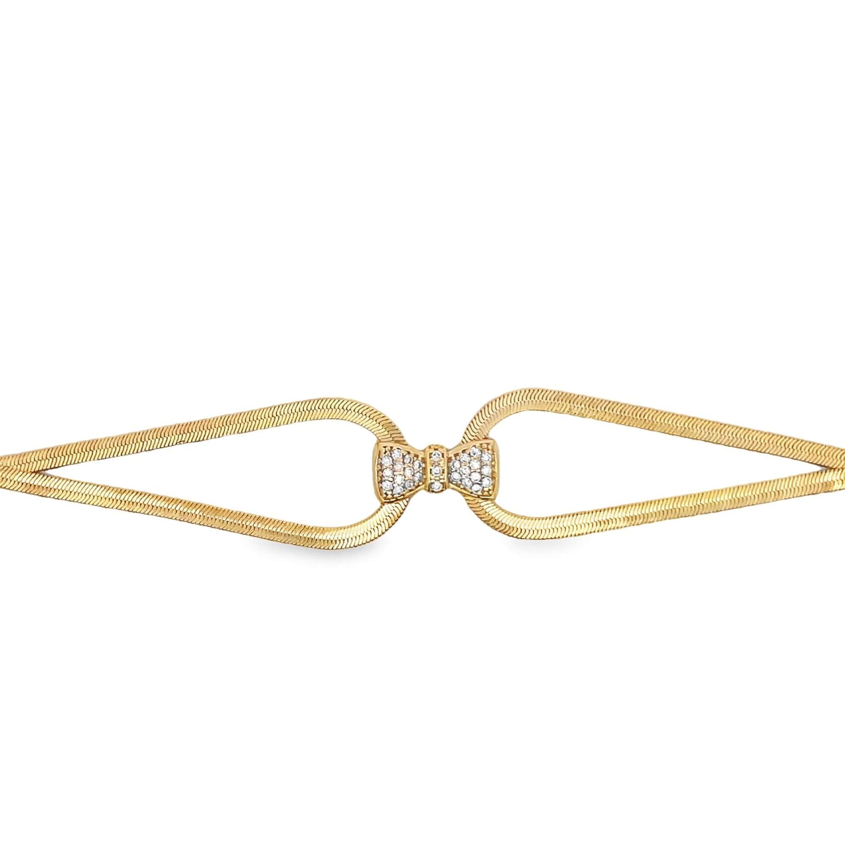 A gold herringbone chain bracelet features a sparkling diamond-encrusted bow clasp at the center.