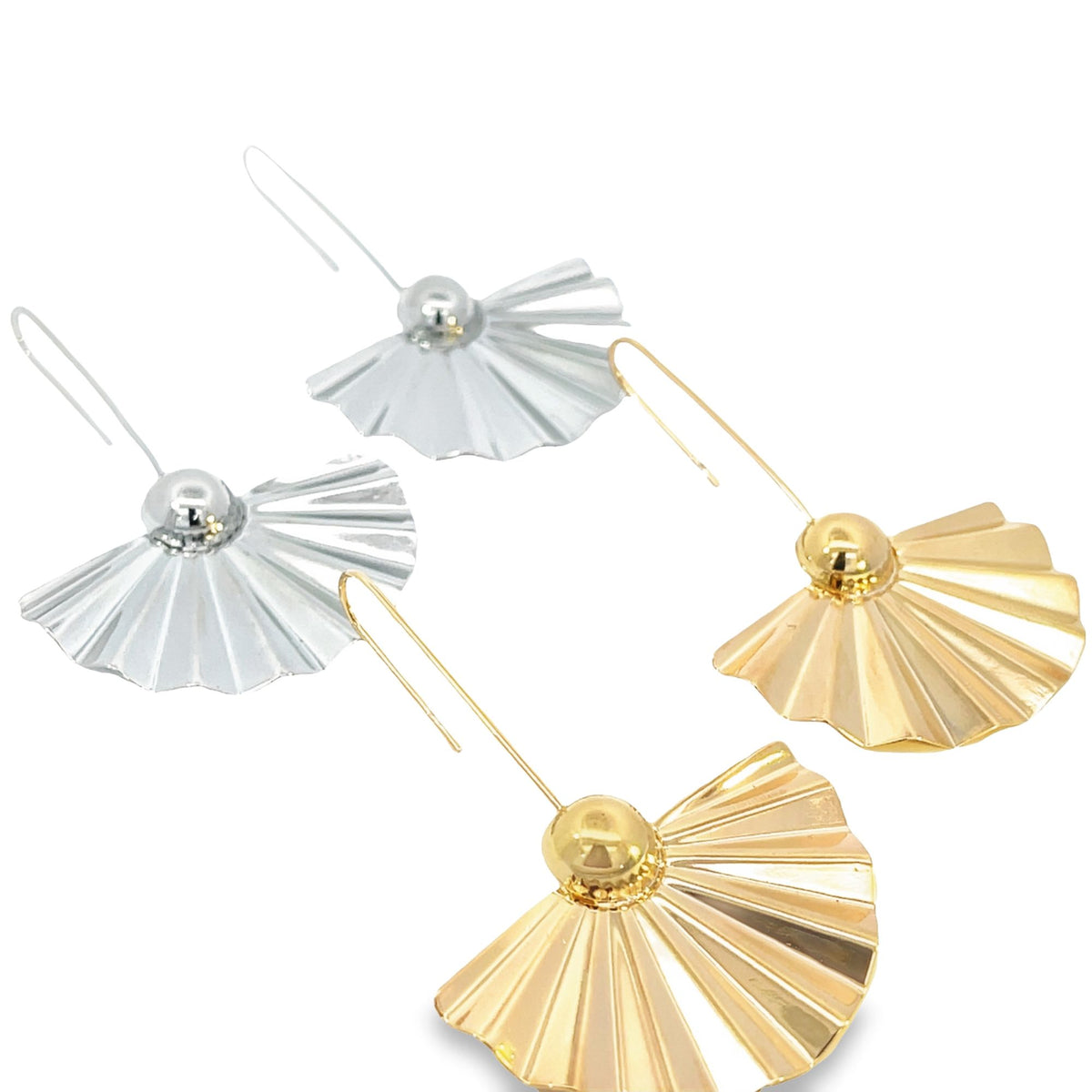 A pair of silver and gold fan-shaped dangle earrings lie against a clean white background.
