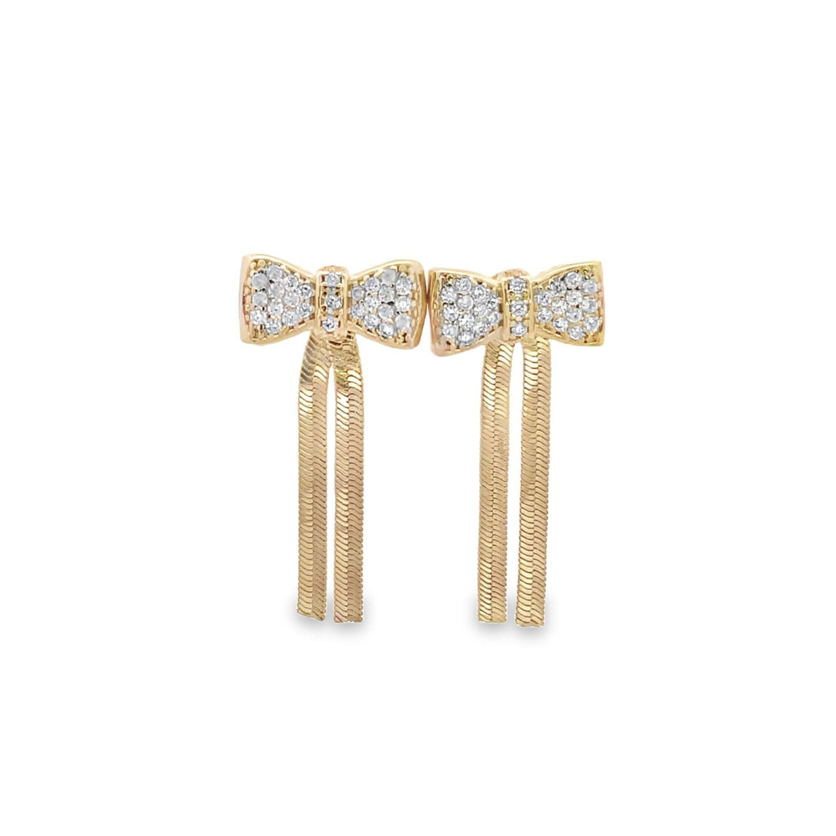 A pair of gold bow-shaped drop earrings sparkle with pavé diamonds and feature dangling herringbone chain fringe.