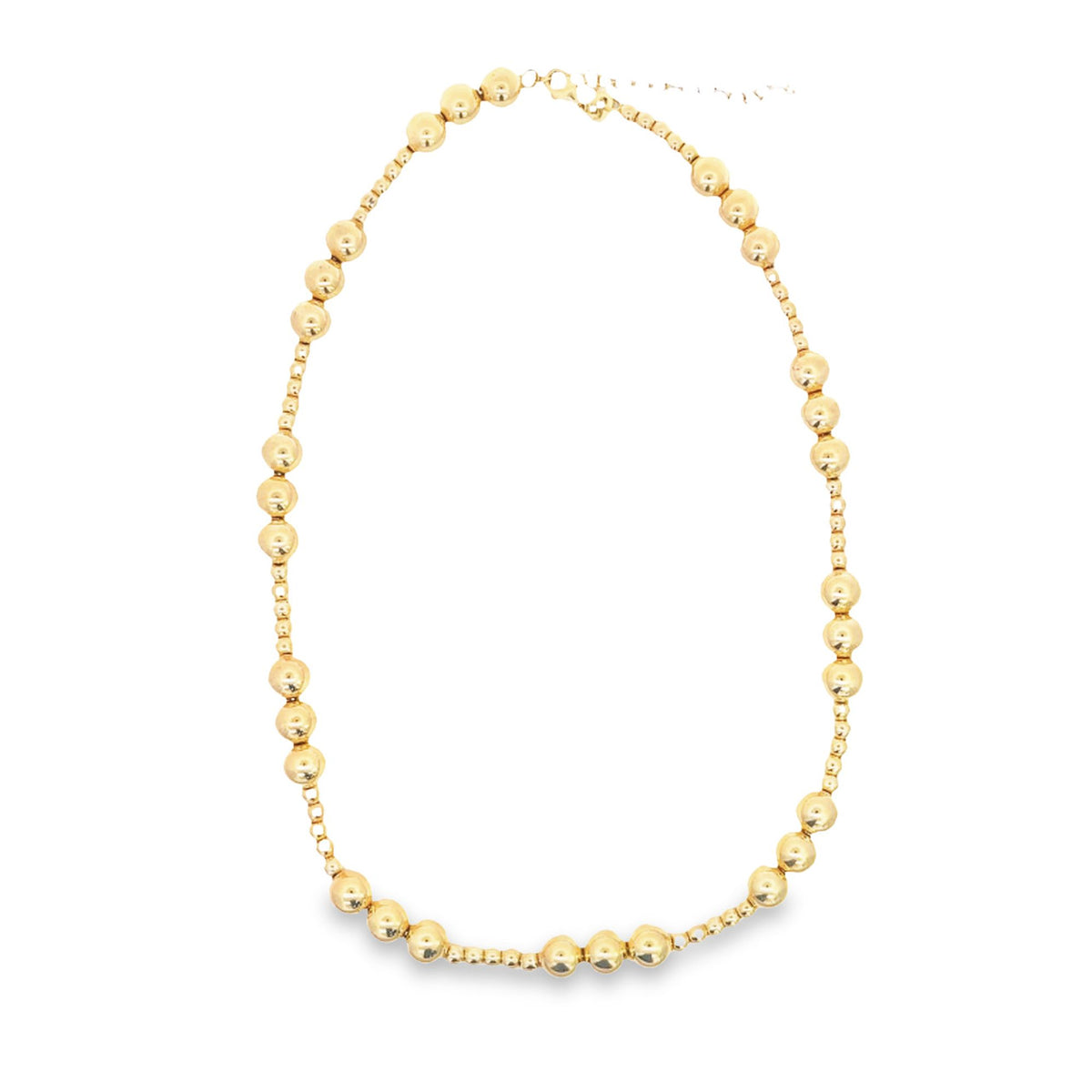 A delicate gold bead necklace rests in a circle on a clean white background.
