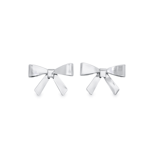 A pair of polished silver bow stud earrings resting against a clean white background.