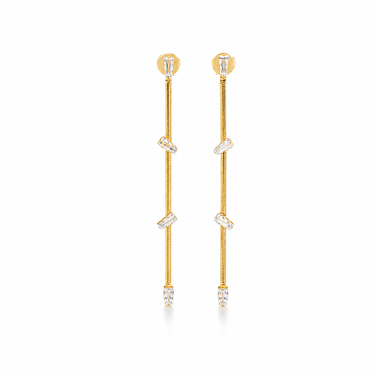 A pair of elegant long gold drop earrings feature delicate chains studded with sparkling baguette-cut crystals against a clean white background.