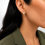 Shop geometric triangle stud earrings featuring sparkling oval CZ stones. Crafted in 18K Gold Filled and available in Gold and Rhodium finishes.