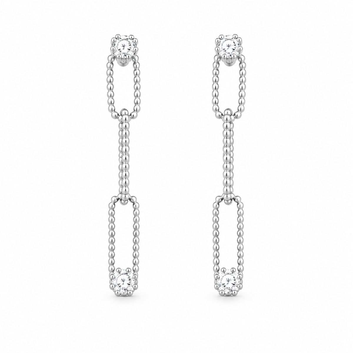 A pair of elegant silver diamond drop earrings features interlocking beaded links accented with sparkling gemstones against a clean white background.