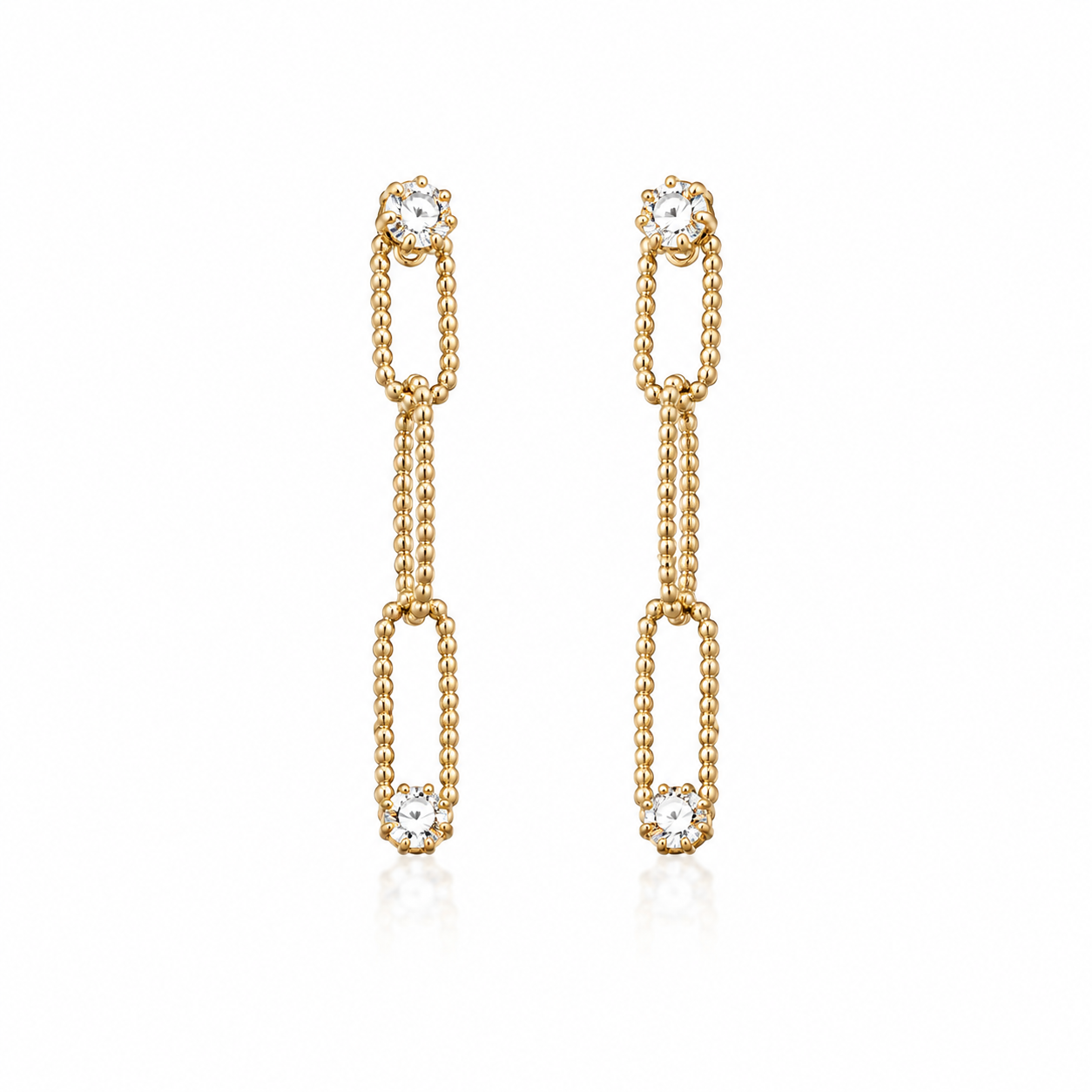 A pair of elegant gold chain dangle earrings sparkles with brilliant-cut diamonds against a clean white background.