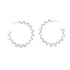 A pair of silver spiral hoop earrings rests against a clean white background.