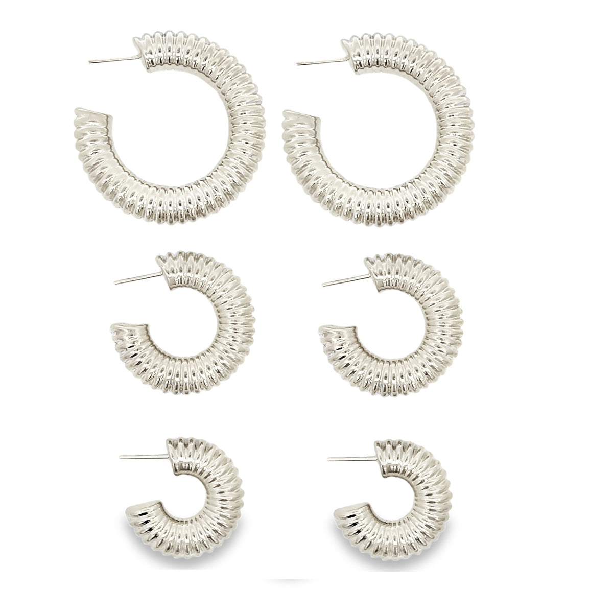 A collection of three pairs of chunky, textured silver hoop earrings display a graduated size arrangement against a clean white background.