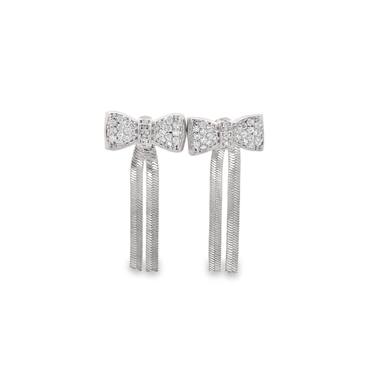 A pair of sparkling diamond bow earrings with dangling silver fringe chains shines against a plain white background.