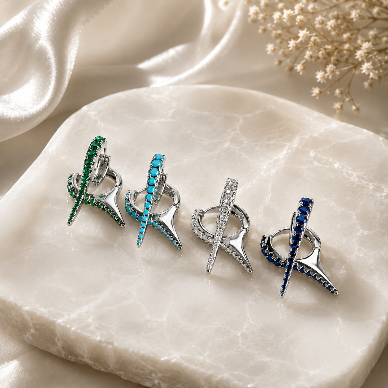 Premium Gold Filled spike huggie earrings featuring brilliant cubic zirconia. Available in Emerald Green, Turquoise, Clear, and Sapphire Blue for a modern everyday look.