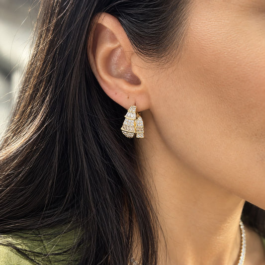Shop elegant pave hoop earrings featuring baguette-cut and round cubic zirconia stones in a dimensional geometric design. 18K Gold Filled.