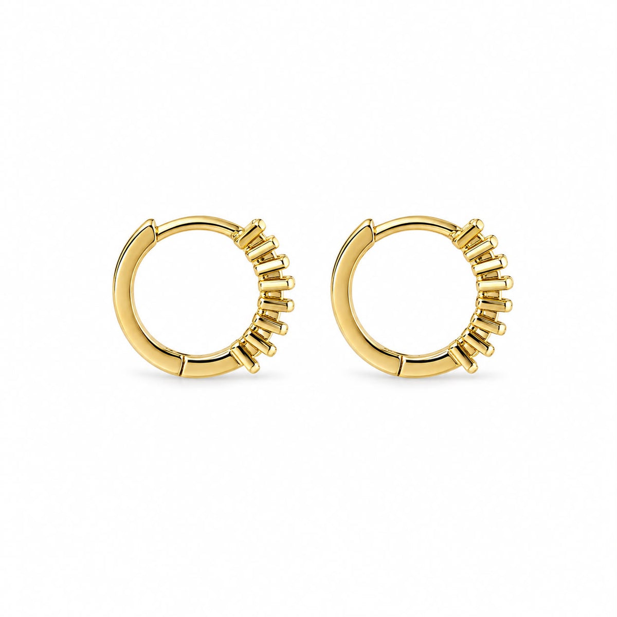 A pair of polished gold hoop earrings features a row of vertical baguette accents along one side against a clean white background.