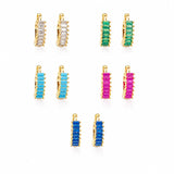 Elegant 18K Gold Filled huggie hoop earrings featuring baguette-cut cubic zirconia. Available in clear, emerald, turquoise, sapphire blue and fuchsia. Perfect for everyday wear.