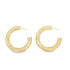 A pair of thick, polished gold hoop earrings rests against a clean white background.