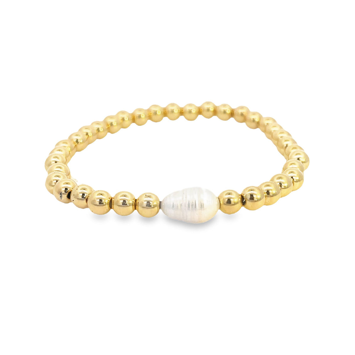 A gold beaded stretch bracelet features a central teardrop-shaped baroque pearl.