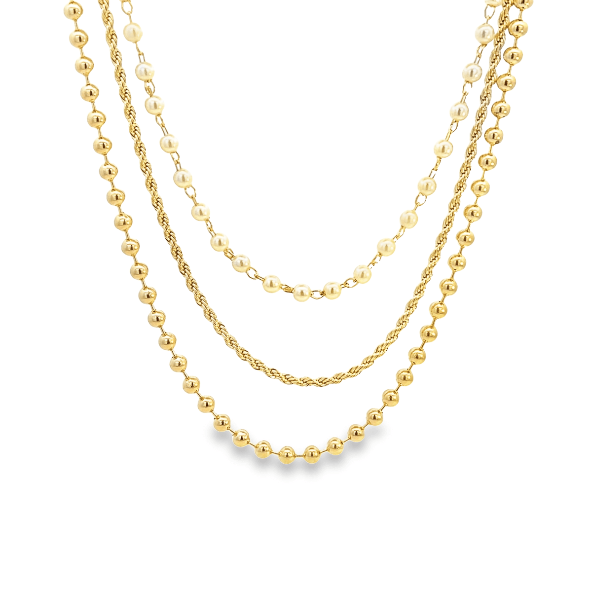 A layered gold chain necklace features a combination of beaded strands, pearls, and a twisted rope design.