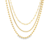 A layered gold chain necklace features a combination of beaded strands, pearls, and a twisted rope design.