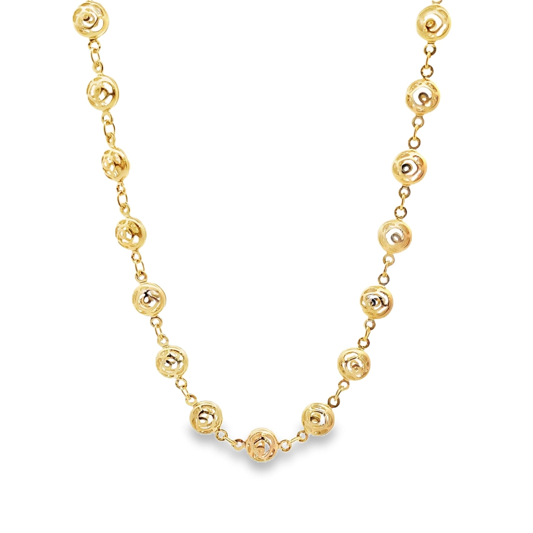 A delicate gold chain necklace features intricately patterned circular stations linked together against a clean white background.