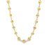 A delicate gold chain necklace features intricately patterned circular stations linked together against a clean white background.