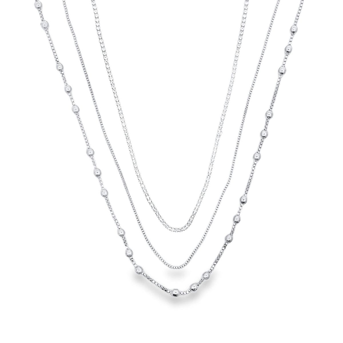 A layered silver chain necklace features delicate box chains mixed with strands adorned with small polished beads.