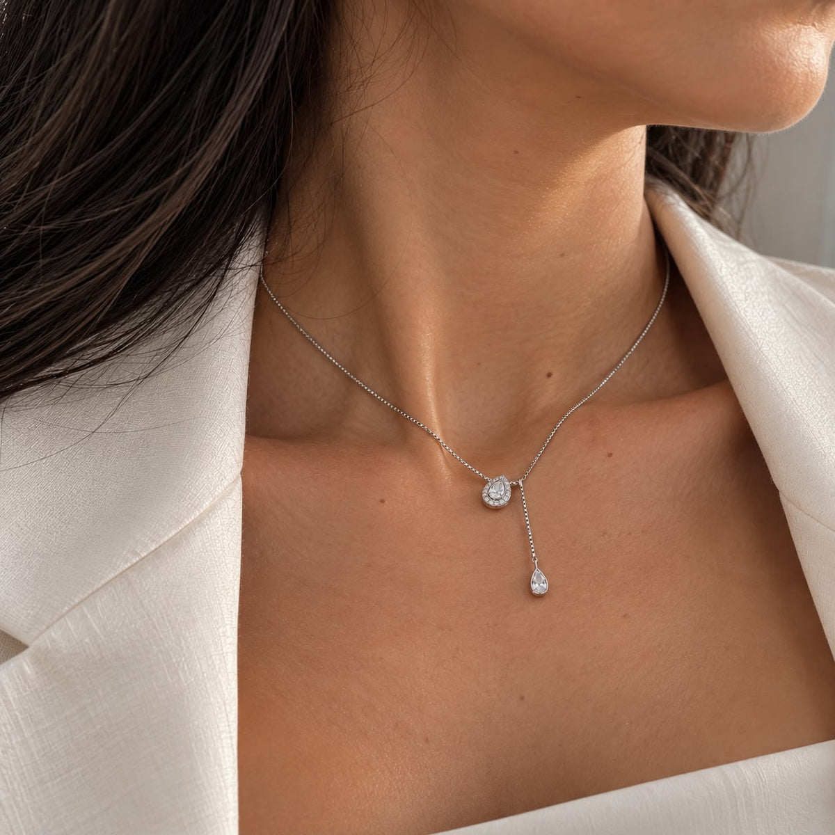 Shop the Teardrop CZ Lariat Necklace featuring sparkling cubic zirconia, a teardrop center pendant, and an elegant dangling drop for a refined Y-necklace look.