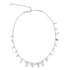 A silver charm necklace dangles against a white background, featuring celestial charms like stars and crescent moons alongside tiny hearts.